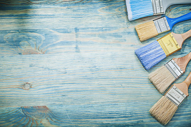 istock Paintbrushes on wooden board copy space construction concept 636276822