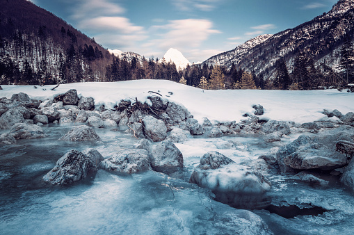 Frozen moutain river in Italian Alps