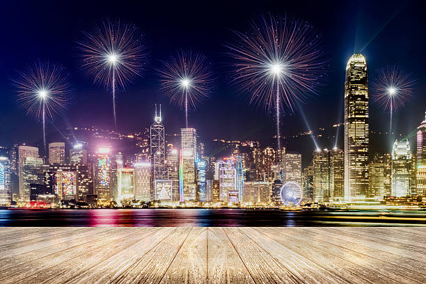 istock Empty wood plank floor with fireworks over cityscape at night 636276960
