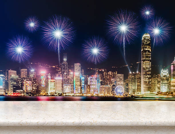 istock Empty white glossy marble table top with fireworks over cityscap 636277164