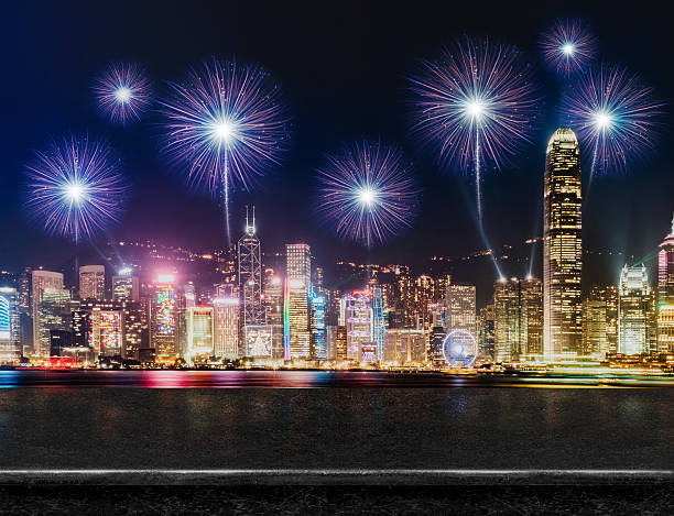 istock Empty black glossy marble table top with fireworks over cityscap 636277264