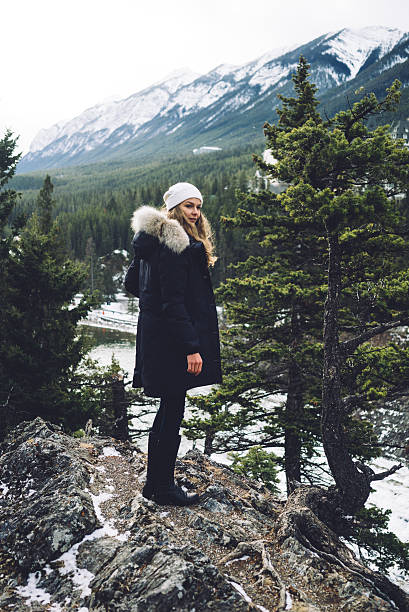 istock Beautiful girl on a cliff overlooking rivers, forests and mountains 636277502