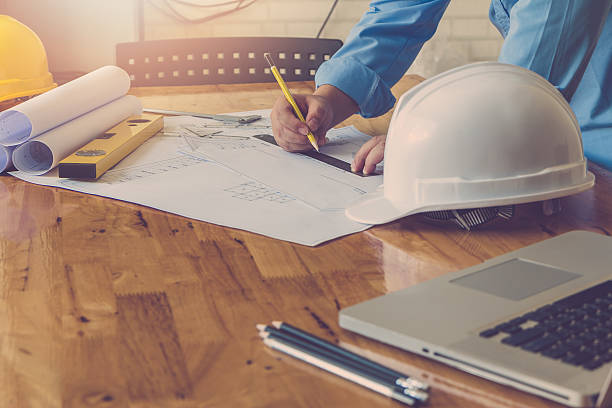 istock Architect concept, Architects working with blueprints in the office, Vintage 636277632