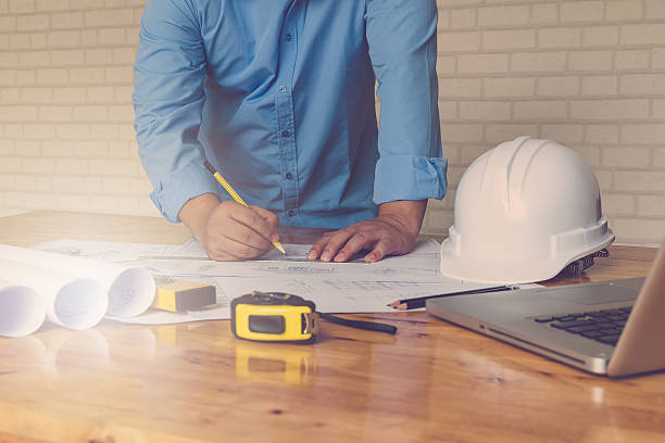 istock Architect concept, Architects working with blueprints in the office, Vintage 636277664