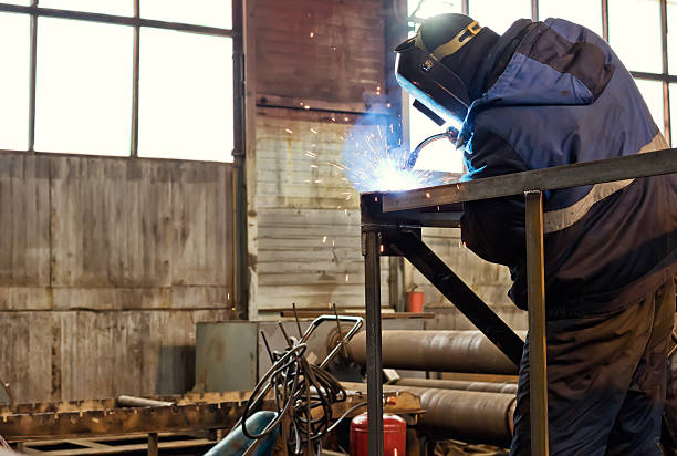 istock Semi-automatic welding of metal structures in the shop 636279138