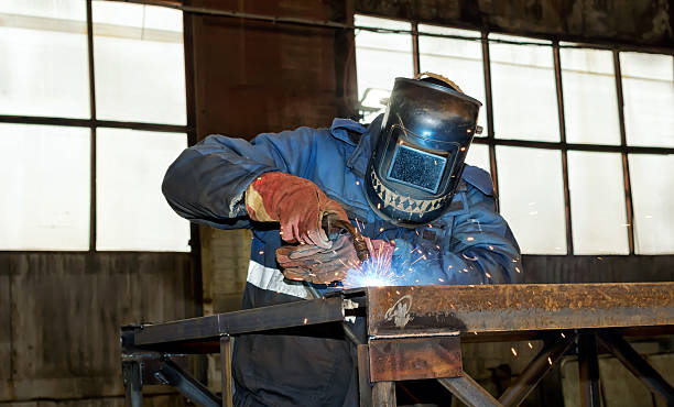 istock Semi-automatic welding of metal structures in the shop 636279158