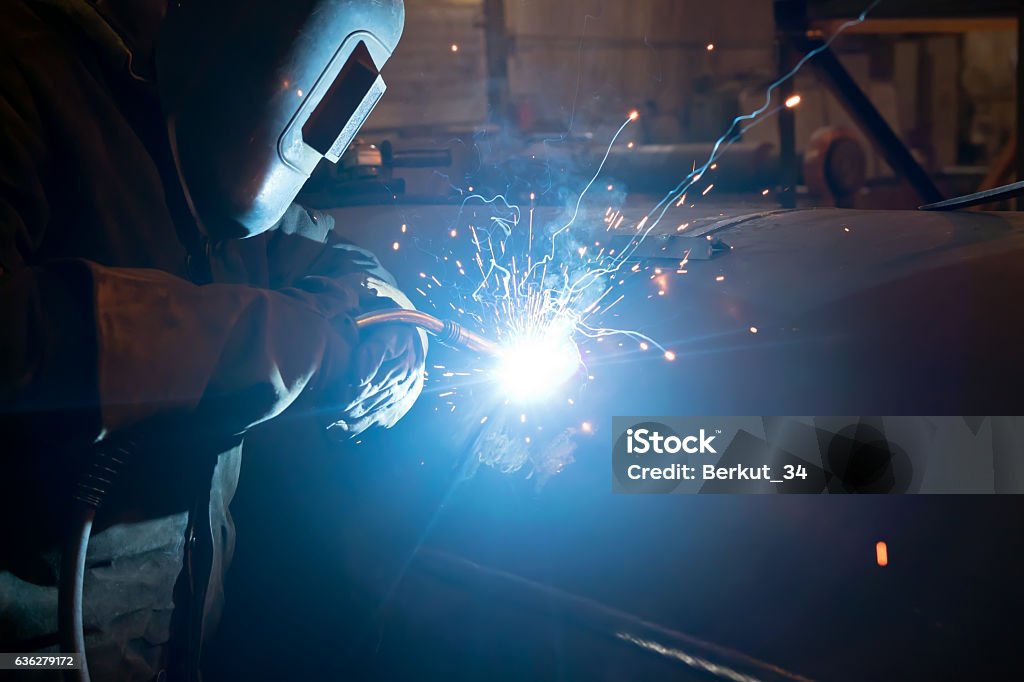 Repair of parts of the apparatus for manual arc welding Welding large diameter pipe in workshop conditions by the method of semi-automatic welding in shielding gases Adult Stock Photo