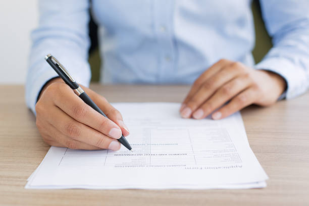 istock Cropped View of Person Completing Application Form 636279624