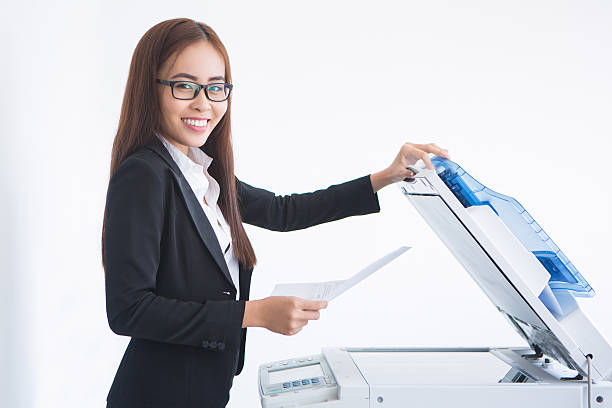 Happy Asian Business Lady Using Copier Machine
