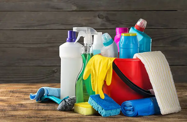 Photo of Variety house cleaning product on wood table