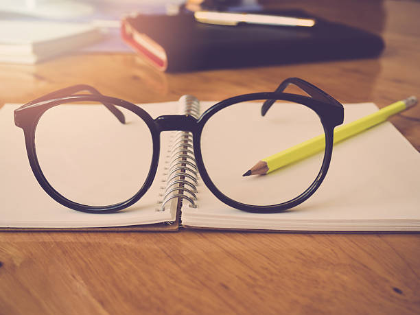 istock Education and office concept. Pencil notebook and eyeglasses, Vintage effect 636284268
