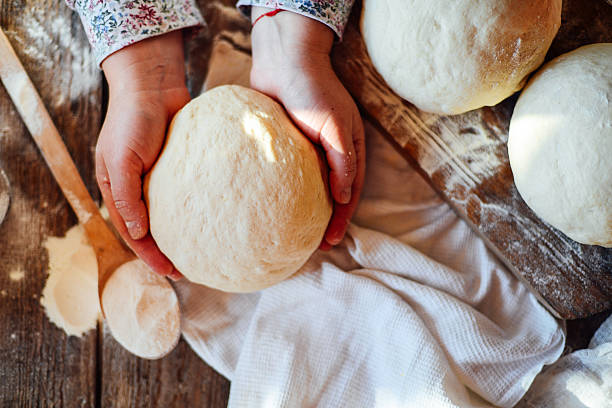 istock Close up view of baker kneading dough. Homemade bread. 636285558