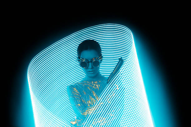 istock Secret Agent with Gun in Blue Light Painting Effect Backdrop 636287116