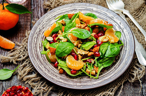 istock Spinach tangerines pomegranate avocado almonds walnuts salad 636287472