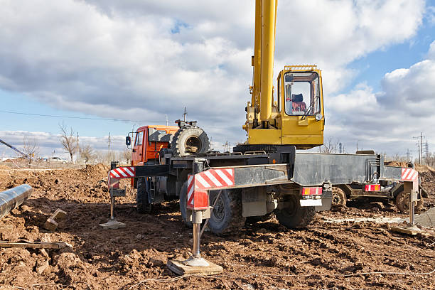 istock Laying of main pipeline in field using a truck crane 636287518