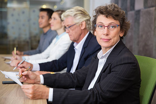 istock Confident senior woman sitting at conference 636287632