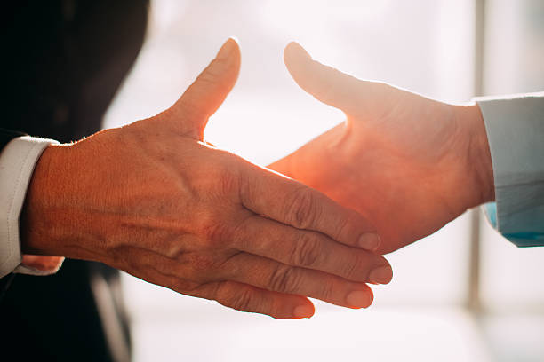 istock Business partners reaching hands to shake it 636287686