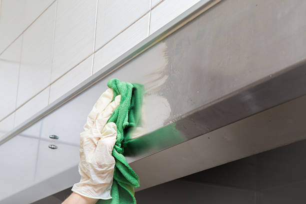 istock Hand in protective glove with rag cleaning kitchen equipment. 636289182