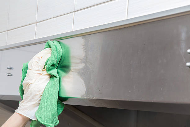 istock Hand in protective glove with rag cleaning kitchen equipment. 636289206