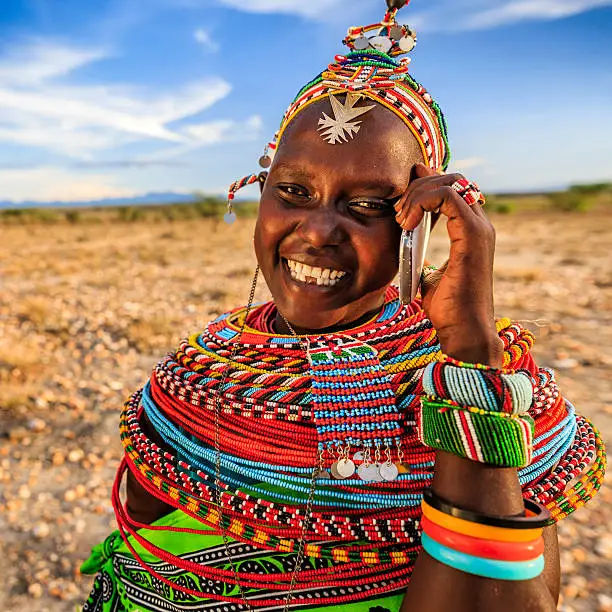 Photo of African woman from Samburu tribe using mobile phone, Kenya, Africa