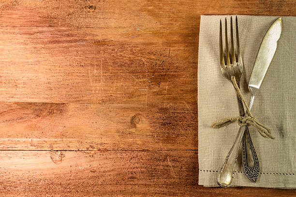 istock Vintage fork and knife on wooden background 636294060