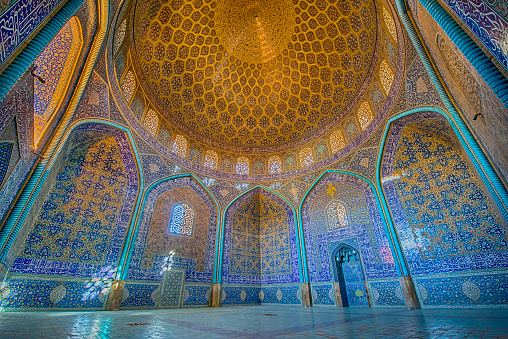 Mosaic decoration made of tiles inside the famous Sheikh Lotfollah Mosque. This mosque is one of the architectural masterpieces of Safavid Iranian architecture, standing on the eastern side of Naghsh-i Jahan Square (also known as Imam or Shah Square) in Isfahan, Iran. The construction of the mosque dates back to 1603 until 1615.