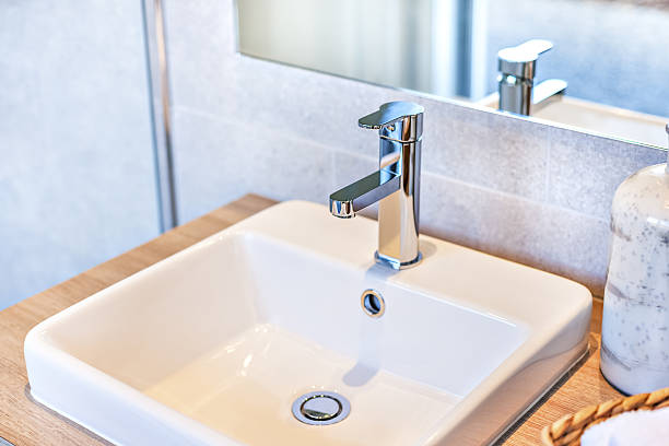istock Closeup of a silver taps and ceramic sink 636294580