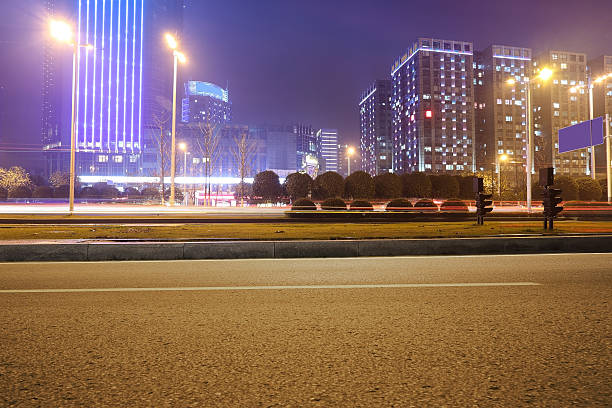 istock Urban road, modern city at night 636294912