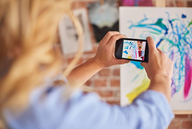 istock Taking picture of her painting 636295982