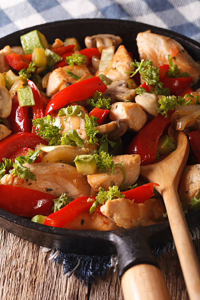 istock Chicken breast fried with mushrooms, peppers and zucchini closeup 636296844