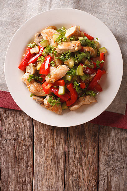 istock Chicken saute with mushrooms and vegetables close-up. vertical 636296984