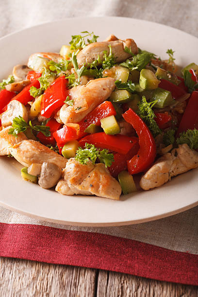 istock Chicken saute with mushrooms and vegetables close-up. Vertical 636297134