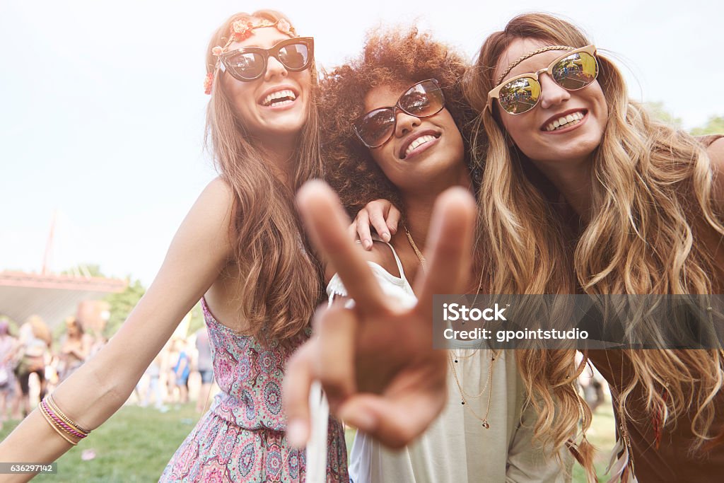 Peace sign and three friends Music Festival Stock Photo