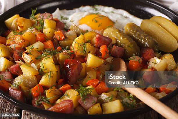 Swedish Cuisine Pyttipanna With Fried Egg And Pickled Cucumbers Stock Photo - Download Image Now