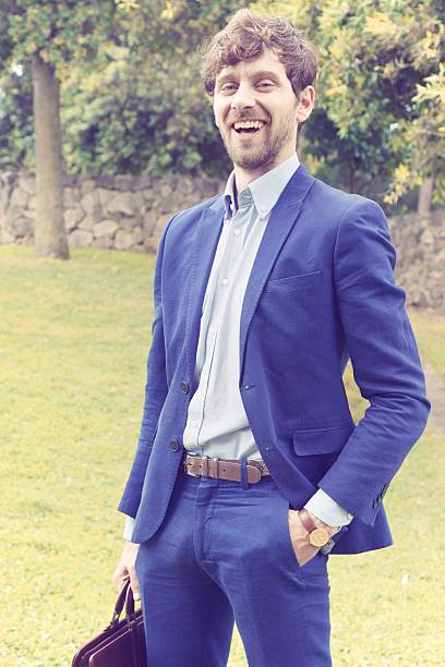 istock Happy successful business man standing in a park 636298574