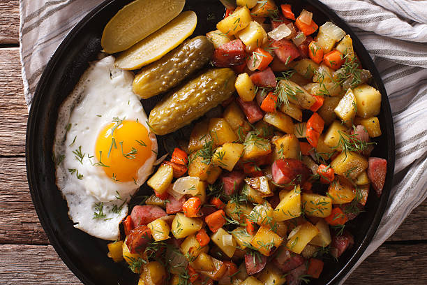 istock Scandinavian fried potatoes with sausages, eggs and pickled closeup 636298726