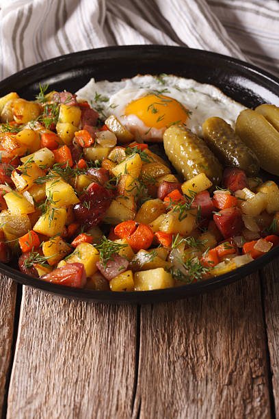 istock Scandinavian fried potatoes with sausages, eggs and pickled closeup 636299288