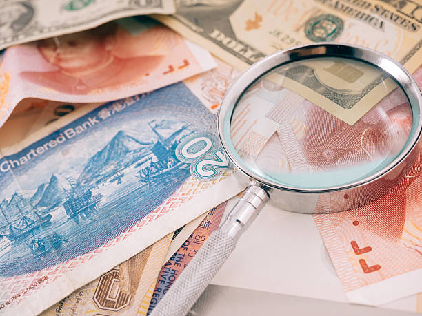 istock magnifier on group of paper currency 636299516