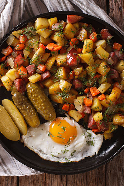 istock Scandinavian fried potatoes with sausages, eggs and pickled 636299530