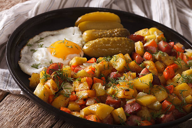 istock Norwegian food pyttipanne: fried potatoes with sausages, eggs 636299610