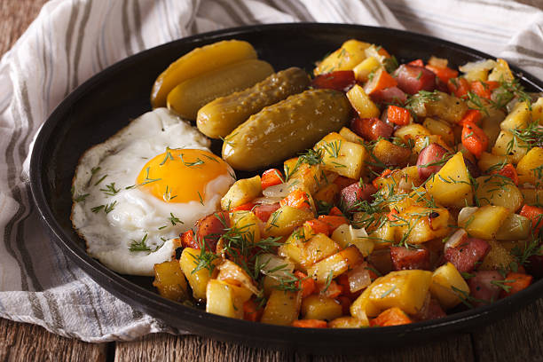istock Scandinavian fried potatoes with sausages, eggs and pickled closeup 636299648