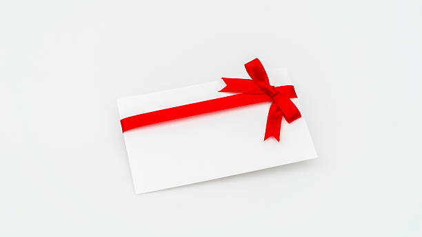 istock Blank card with red ribbon on white background 636300378