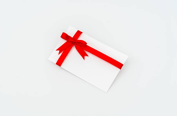 istock Blank card with red ribbon on white background 636300592