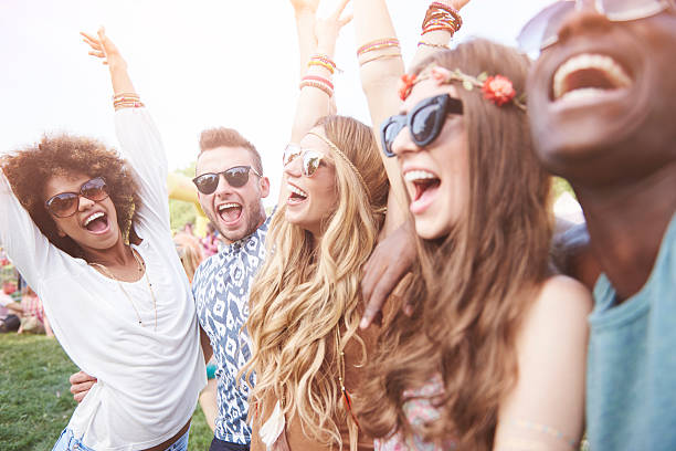 istock Friends dancing at outside concert 636300692