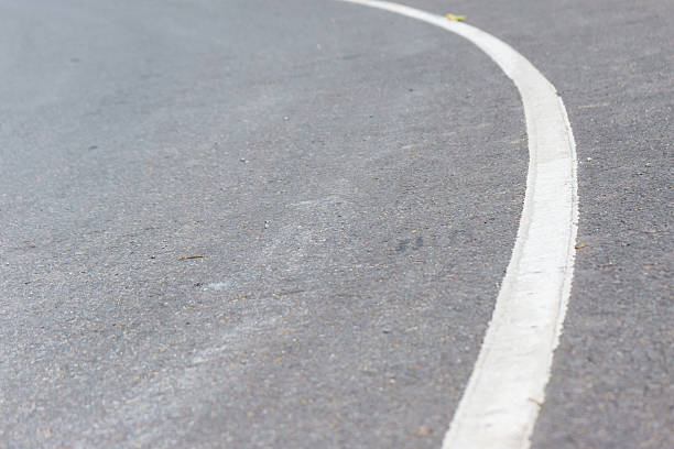 istock The road curves up the mountain. Line white road. 636301196