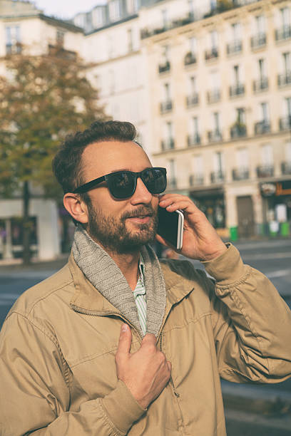 istock Modern guy using smartphone in the European city. 636301900