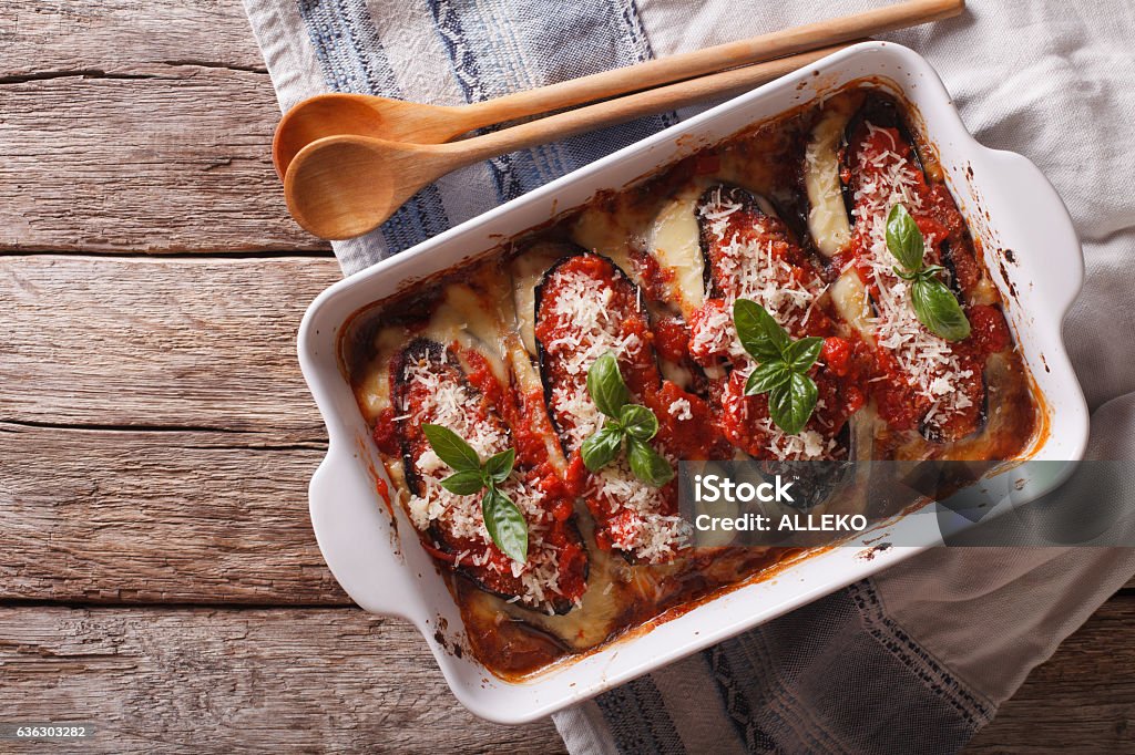 Italian eggplant baked with mozzarella in tomato sauce Italian eggplant baked with mozzarella in tomato sauce close up in baking dish. horizontal view from above Eggplant Stock Photo