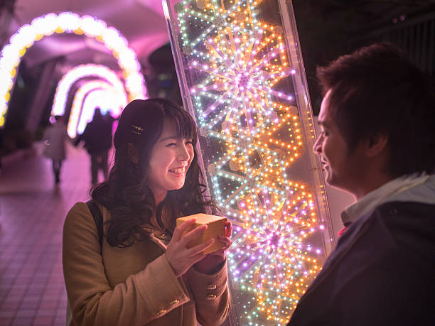 istock Young couple in Christmas lights 636304524