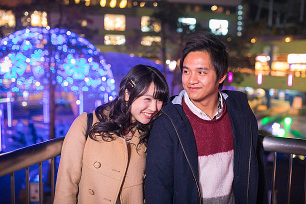 istock Young couple dating in Christmas lights 636305406