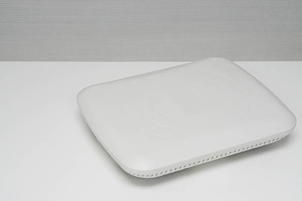 isolated white access point on office desk stock photo